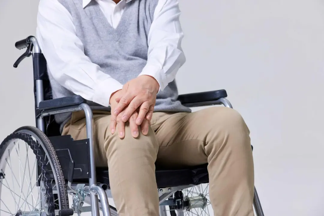 Senior man seated in a wheelchair, emphasizing the importance of early joint care for mobility